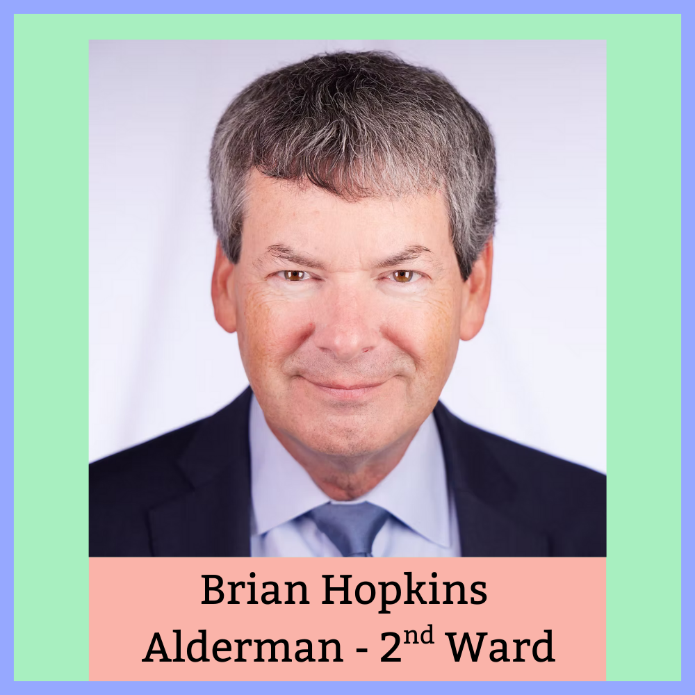 Headshot of a man with short gray hair, wearing a dark suit and light blue tie, against a light background. Text below reads 'Brian Hopkins, Alderman - 2nd Ward'.