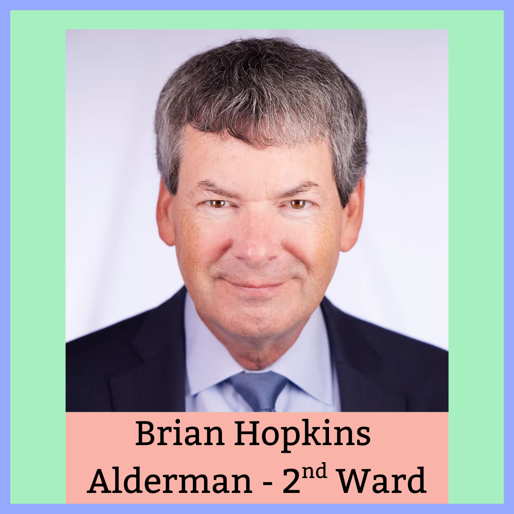 Professional portrait of a man with short, slightly wavy, gray hair, wearing a dark suit and tie, against a soft, neutral background. Text overlay reads: 'Brian Hopkins Alderman - 2nd Ward'.